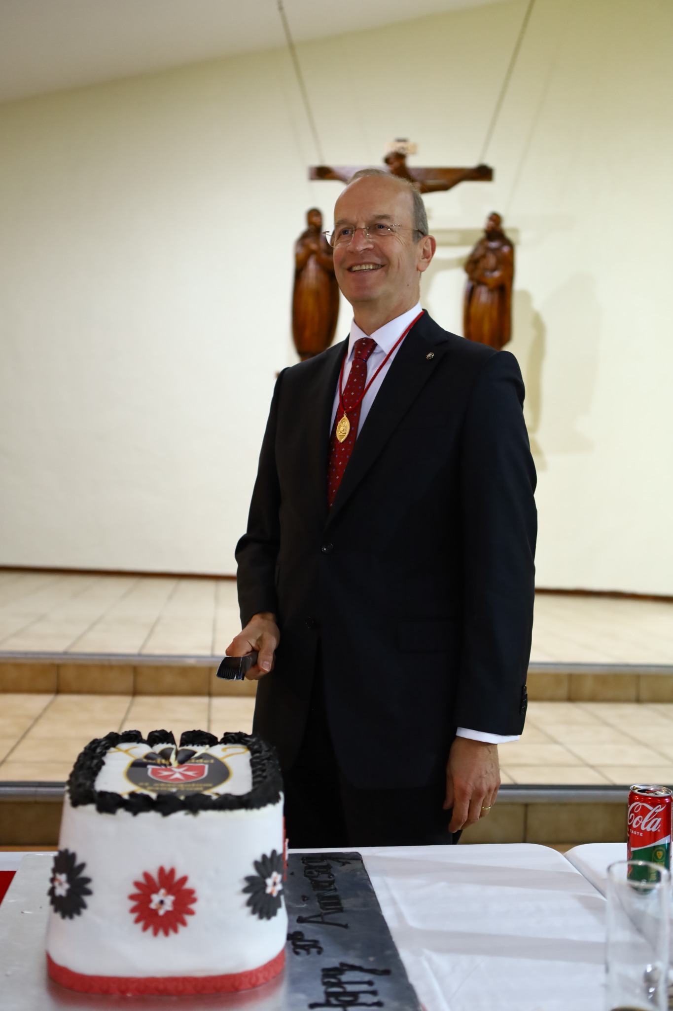 Major General Dr Josef D. Blotz beside the anniversary cake