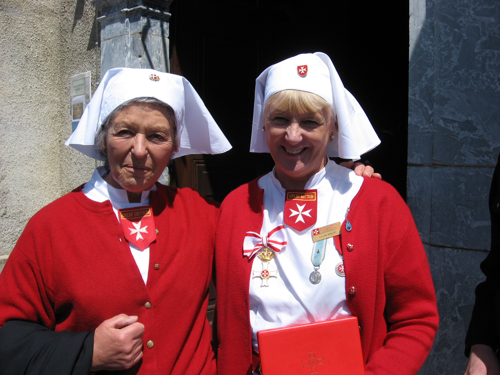 Lillian Molloy wearing the Cross with Crown pro Merito Melitensi in Lourdes