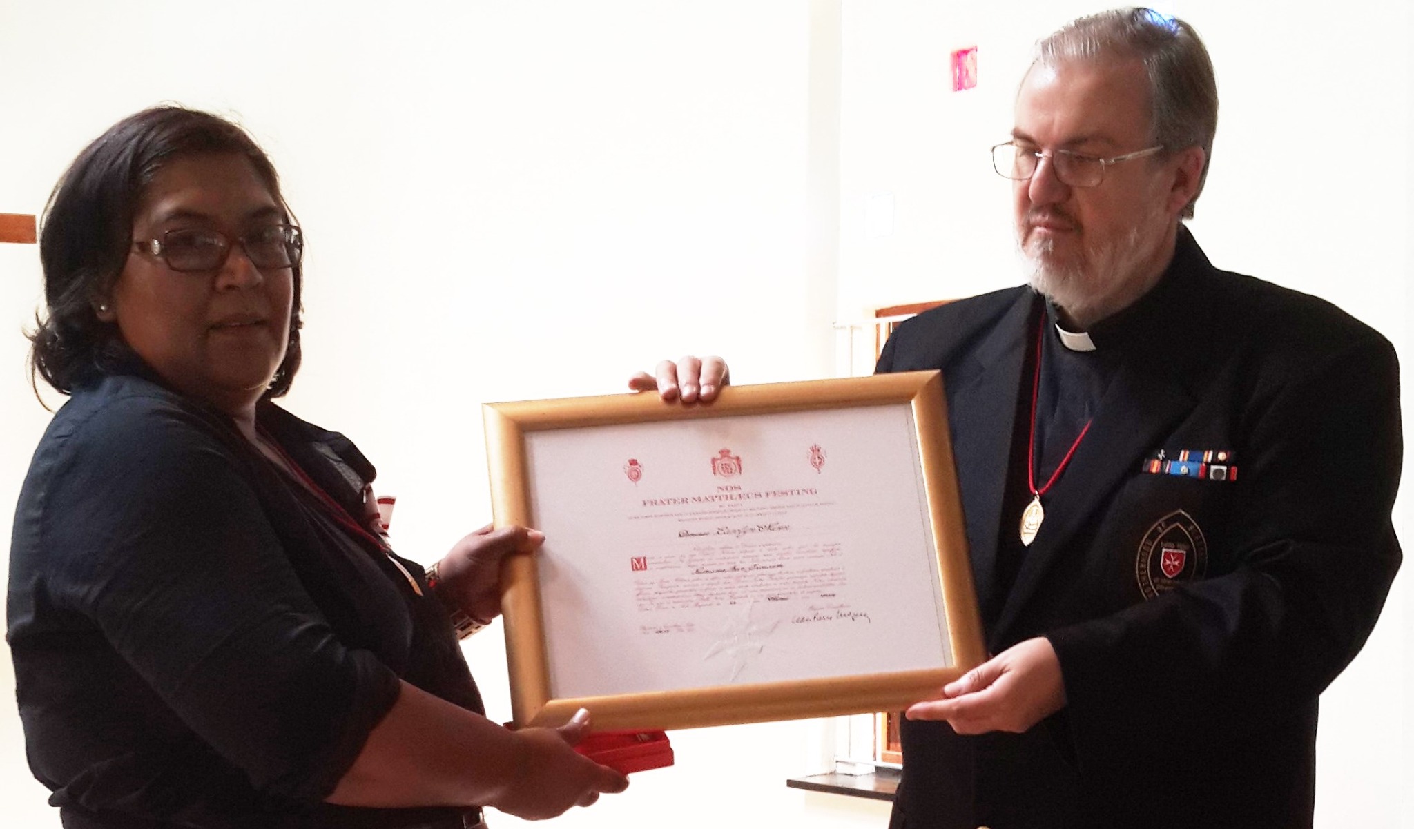 Carolyn Nunn receiving the Bronze Medal pro Merito Melitensi