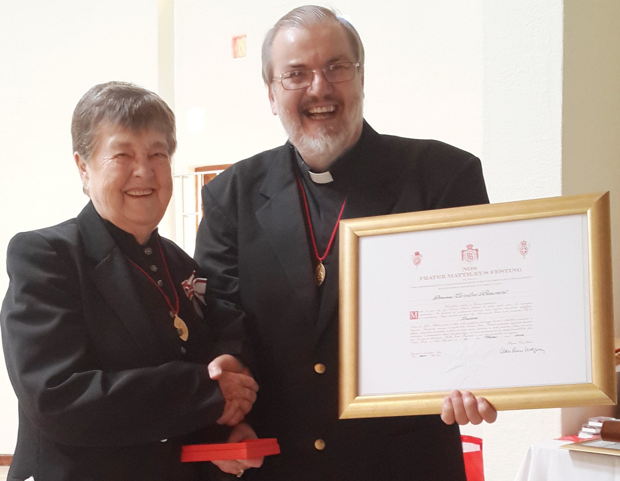 Yvonne Renaud receiving the Silver Medal pro Merito Melitensi